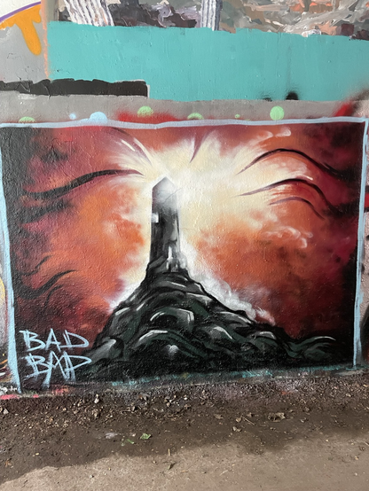 Mystical lighthouse. Flaming red dark background. By bad dad on the parkland walk north london.