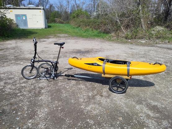 A Kayak om a boat trailer behind a brompton bike