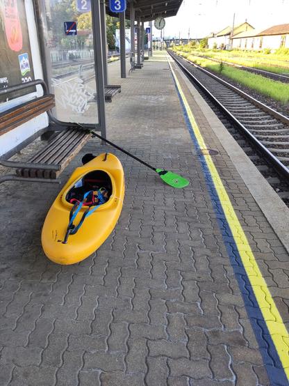 A topolino whitewater kayak at a train station