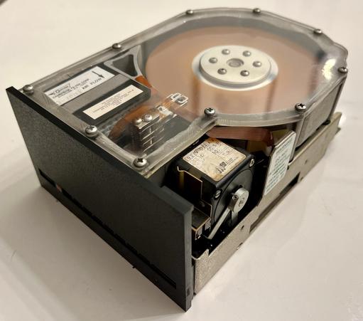 Seagate ST-506. The read/write head did in a linear motion, not circular.