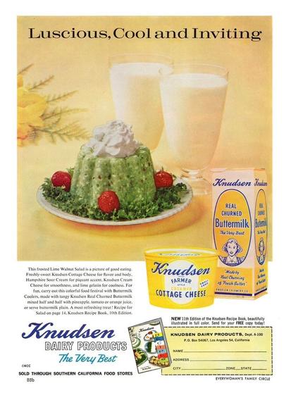 the text reads in part - Luscious, Cool and Inviting. There is a plate with a green cotage cheese molded food object. It has whipped cream topping and strawberry garnishes. There are two glasses of buttermilk.
