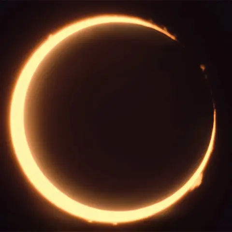 October 14, 2023 annular eclipse as seen along the eclipse grazing line.  Many prominences can be seen along the edge of the Sun.