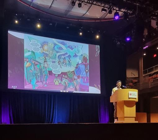 Dr AJ Escoffery with a slide showing a comic book page