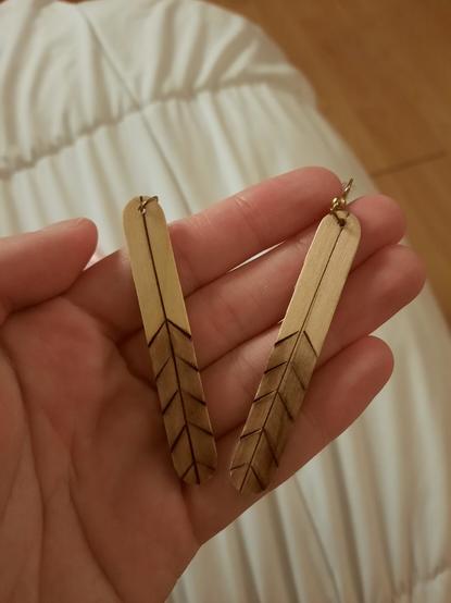 Another pair of wooden earrings made to look like bird feathers.