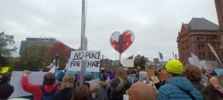 Many people showing up for community, with signs.

One in particular reads:

No place for hate.