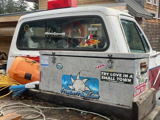 White truck cab with stickers including one that says “try love in a small town”