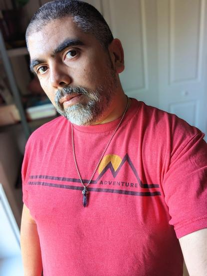 Picture of me wearing a red T-shirt with the words "Adventure."