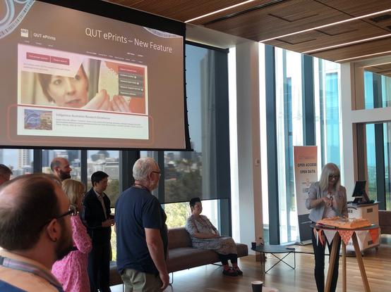 Photo of Paula Callan, Scholarly Communications Librarian, QUT Library, cutting QUT ePrint's 20th birthday cake.