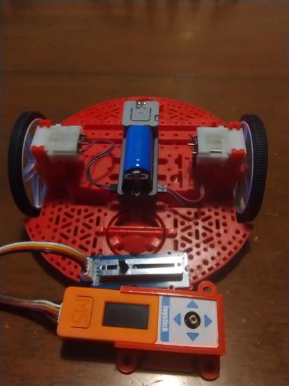 M5Stack Atom Motion on a Pololu robot chassis, with a M5StickC with joystick hat and slider potentiometer.