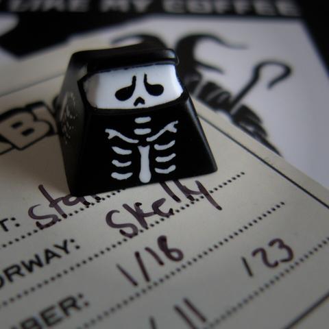 photograph of an artisan keycap with a skeleton design