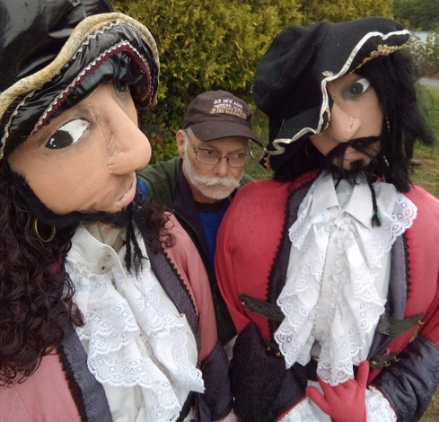 lifelike giant dolls or scarecrows, two dressed up as buccaneers and me in the middle