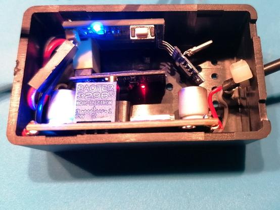 The inside of the prototype box contains a step down module, the ESP-01 on a sensor board and a couple of cable