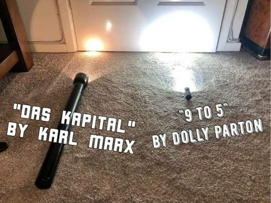 photo of two flashlights on carpet pointed at a nearby wall. one is huge, but shines a small dim light. the other is tiny but shines a bright white illuminating light.

the large dim flashlight has the words "das kapital" by karl marx.

the small bright flashlight has the words "9 to 5" by Dolly Parton.