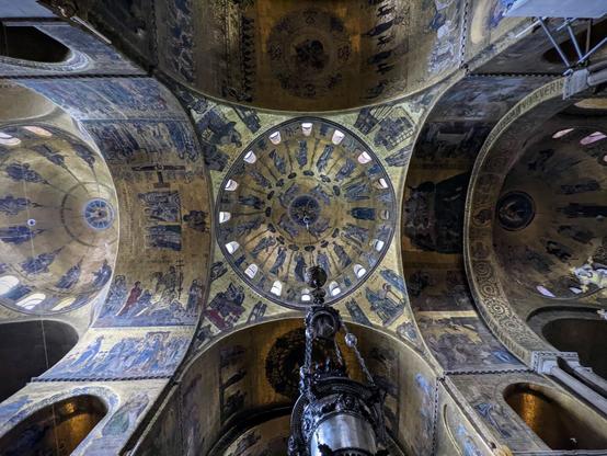 The golden interior roof of an Italian basilica