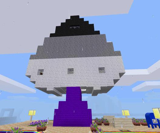 A building in the shape of a spade (playing cards), in the asexual pride flag colors (black, gray, white, violet).