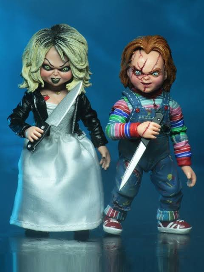 Chucky and Bride of Chucky dolls with large knives.