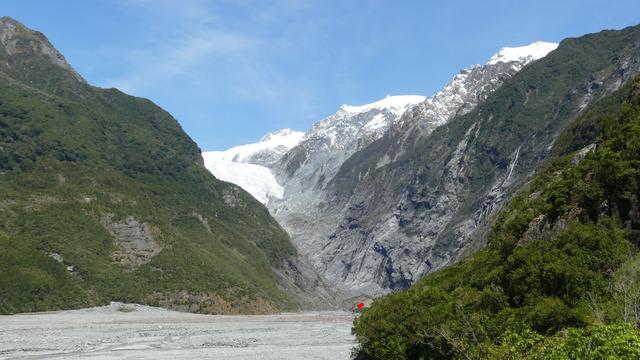 Image shows Franz Josef Glacier, which has been retreating for more than a decade. A red dot added near the bottom right of the image shows where the glacier reached when the photographer last visited some 40 years ago