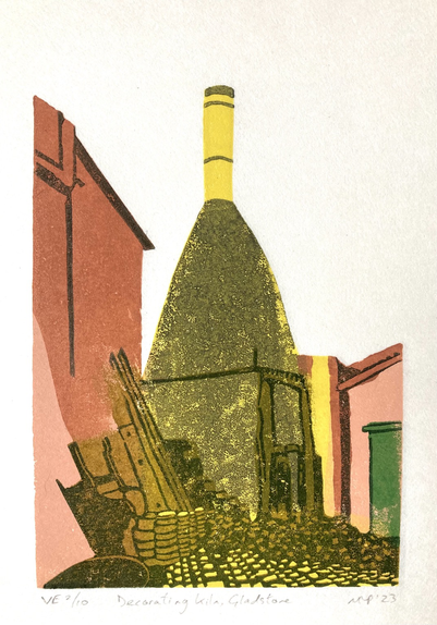 A linocut of a bottle shaped pottery kiln in mustard yellow, roughly textured, with buildings in terracotta either side, and a pile of coal and cobbled floor in front