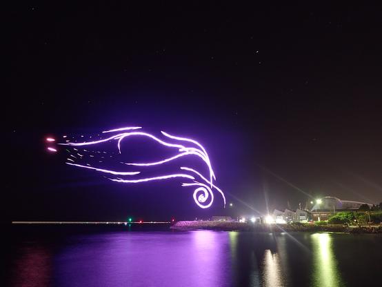 Lighttrails of a flock of drones forming a representation of the Noongar time-before-time.