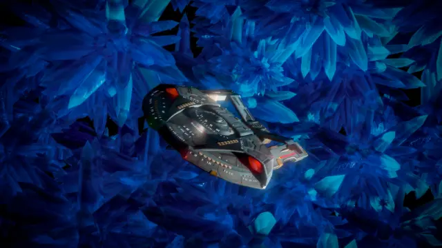 Star Trek Steamrunner class starship seend from right above diagonally, flying towards the viewer. In the background there are clusters of blue crystals