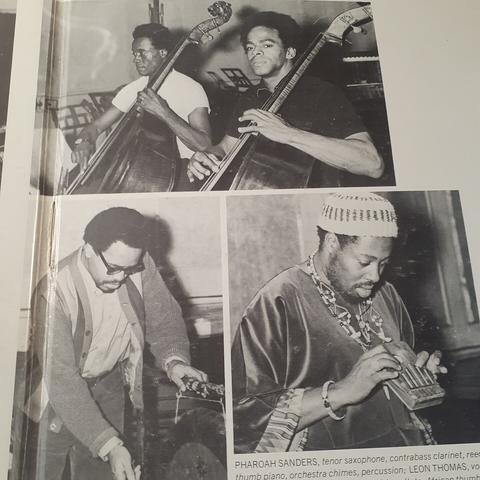 Photos from inside of gatefold sleeve show Cecil McBee and Richard Davis playing two upright basses side-by-side; Roy Haynes playing a gong; and Leon Thomas playing a mbira.