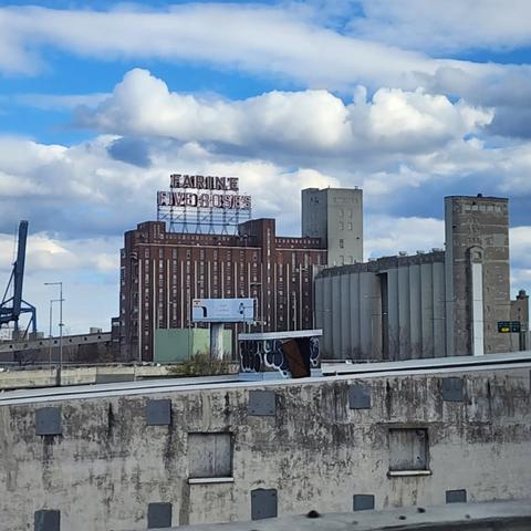 Five Roses flour mill sign on roof of flour mill, with silos in foreground