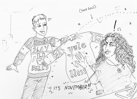 A woman wearing an ugly Christmas jumper holds another ugly Christmas jumper out to her wife, who is a witch and has put up a force field while she works on a laptop. The witch says “it’s November!”