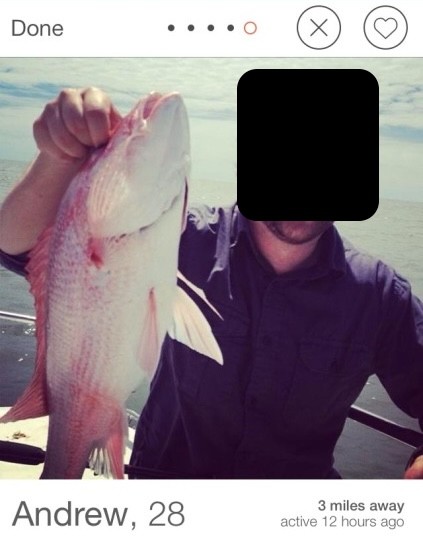 Picture of a guy's dating profile where he's holding a fish