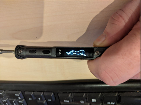 Miniware TS101 soldering iron showing an image of a running cheetah on its little oled display.