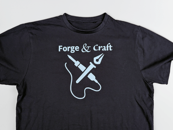 Navy blue t-shirt with Forge & Craft logo in light blue flocked heat transfer vinyl.