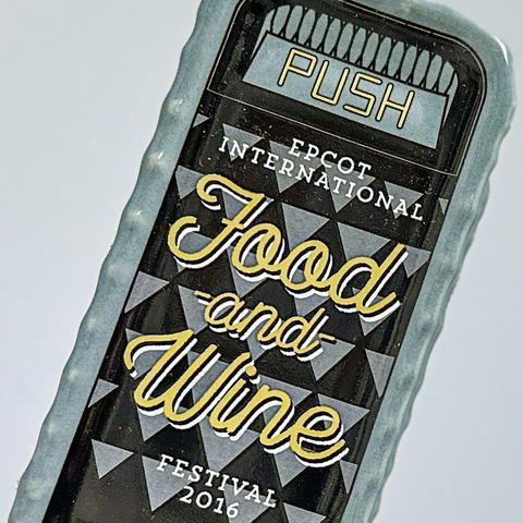 Close-up photo of a salt shaker in the shape of a Disney theme park trash can. Blue and black in color with the test "EPCOT International Food and Wine Festival 2016."