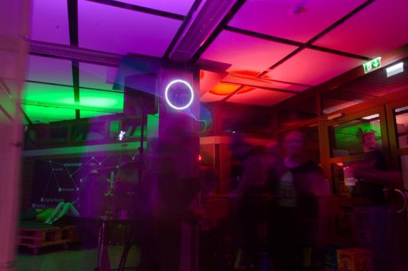 Bar scene with colorful lights and blurred people