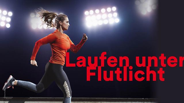 Eine Frau läuft abends auf einer Sportanlage. Über ihr sind die Flutlichter eingeschaltet.