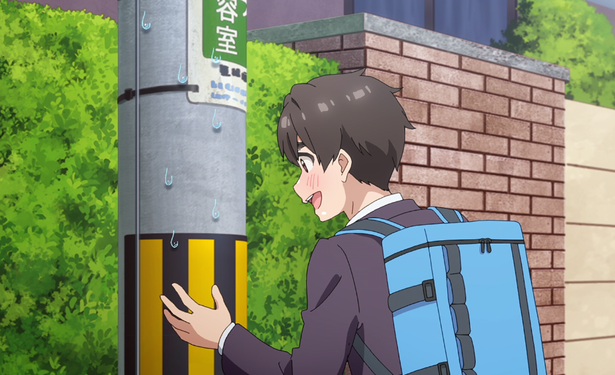 A high school aged boy talking to a telephone pole
