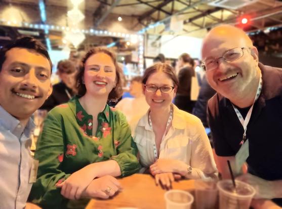 Four people at a table in a bar for a Trivia Night.