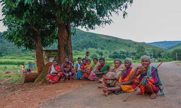 A group of Adivasi women whose relatives have been arrested. Beautiful green hills make the backdrop.