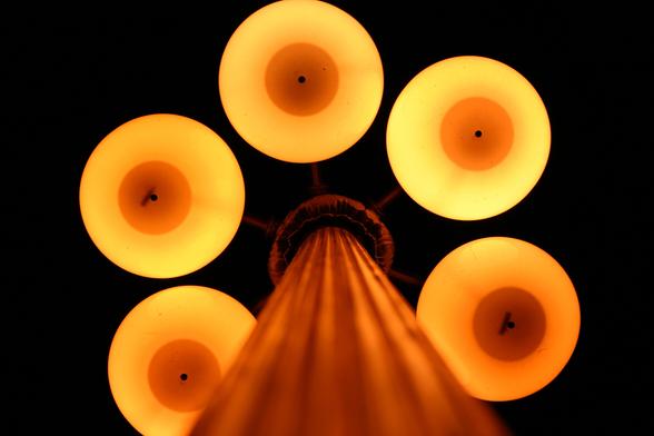 Five sinister looking eyes peer out of the dark, but actually it is just a Chicago light pole at night.