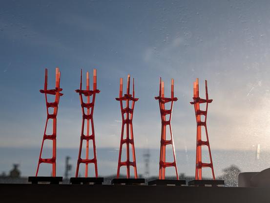 Red Mini Sutro Towers sitting in front of 
 a blue sky