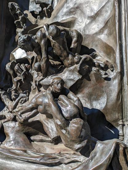 a mass of tortured souls on one side of the door.