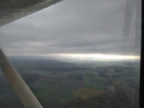 View from airplane after take off in the morning. Dirt on wing.