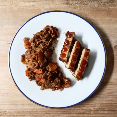 Das fertige Gericht auf dem Teller. Der Tofu wurde in Streifen geschnitten und mit etwas scharfer Sauce betupft.
