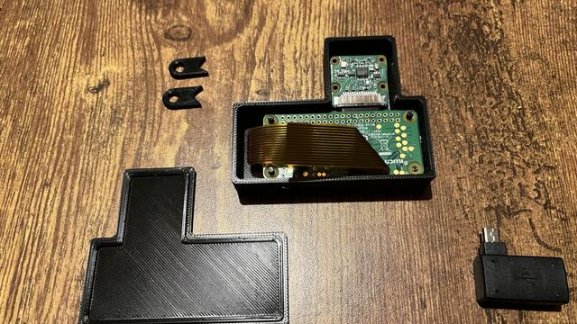 A photo of the rev 1 case design which not only had no active cooling or vent holes, but also inefficiently stacked the camera above the Pi board on the same plane making it a goofy shape. It was my first try and a good stepping stone to making the rev 2 case design!