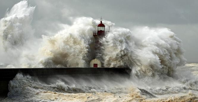 photo - hurricane at lighthouse with waves encompassing