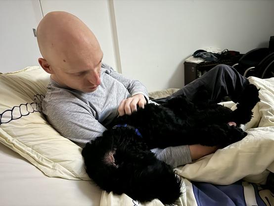 Joy the deep black Labradoodle.
Laying on top of me is *technically* not laying on bed, right?