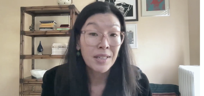 Ai-Jen Poo of Caring Across Generations presents virtually at the annual Endwell Project conference. She sits in a room with three art prints and a carefully arranged bookcase on the wall behind her.
