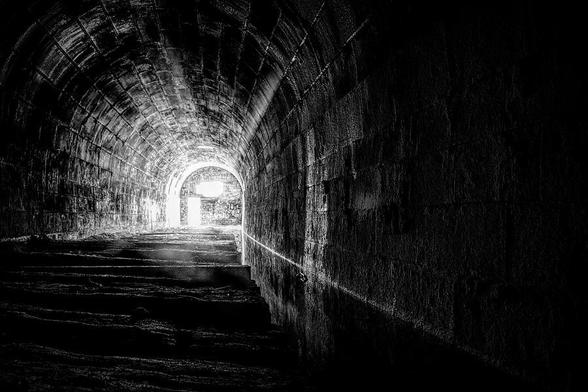 The Merriton Tunnel, also known as the Blue Ghost Tunnel, is an abandoned tunnel on the former Grand Trunk Railway running under the Welland Canal in Ontario. Black and white.