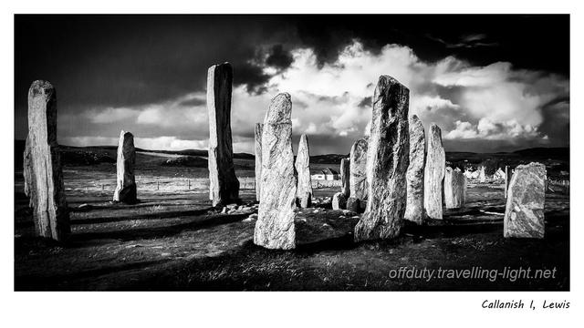 High contrast black and white photo of standing stones against a dramatic sky