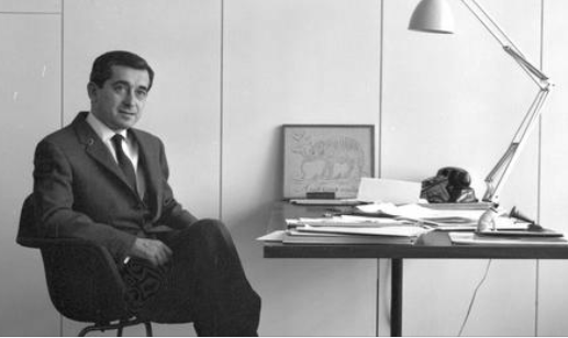 Black-and-white photograph of George Tscherny sitting at his mid-century desk.  image credit: Tscherny family