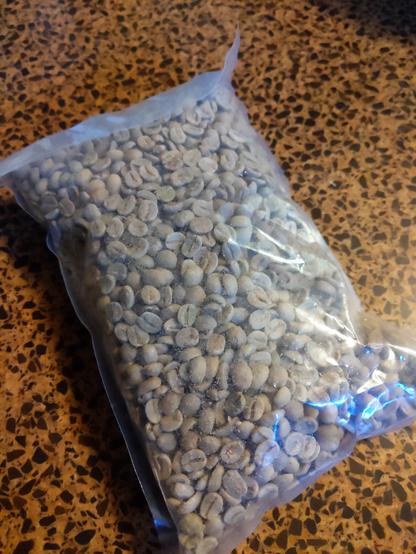 A small bag of raw coffee beans.
