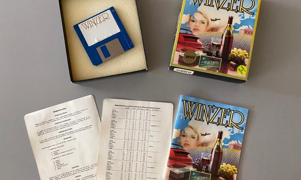 An open video game package, showing the floppy disk and some manuals spread out. The game is about being a winemaker and managing a wineyard.